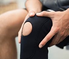 A patient strapping it's knee brace